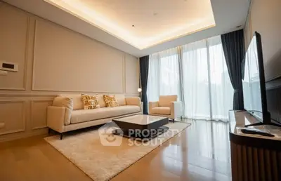 Elegant living room with modern furniture and large windows offering natural light.