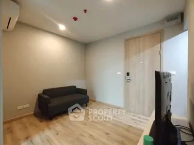 Modern minimalist living room with wooden flooring and compact sofa