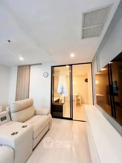 Modern living room with sleek design and cozy seating in a contemporary apartment.