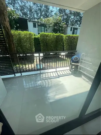 Spacious balcony with garden view in modern residential area