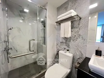 Modern bathroom with glass shower and elegant marble tiles