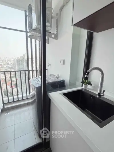 Modern balcony with washing machine and city view, perfect for urban living.