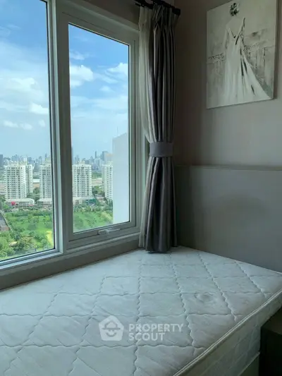 Cozy bedroom with stunning city view through large window, featuring elegant curtains and minimalist decor.