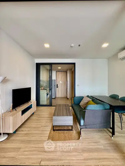 Modern living room with stylish furniture and open kitchen layout in a contemporary apartment.