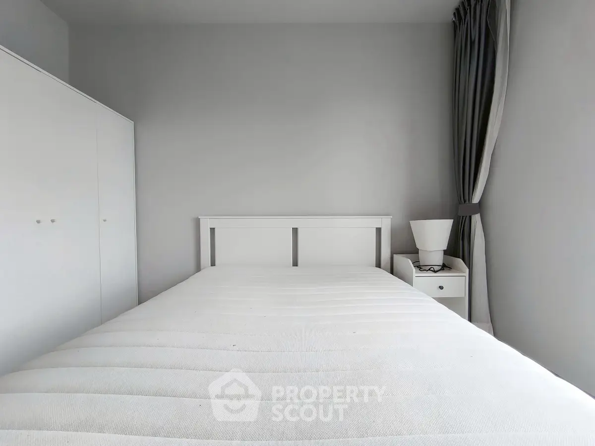 Minimalist bedroom with white furniture and cozy ambiance