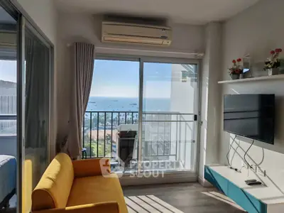 Bright living room with ocean view, modern decor, and vibrant yellow sofa.