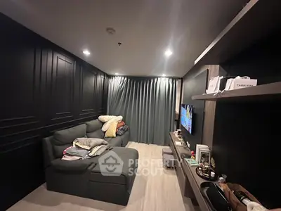 Stylish modern living room with sleek black walls and cozy seating area.
