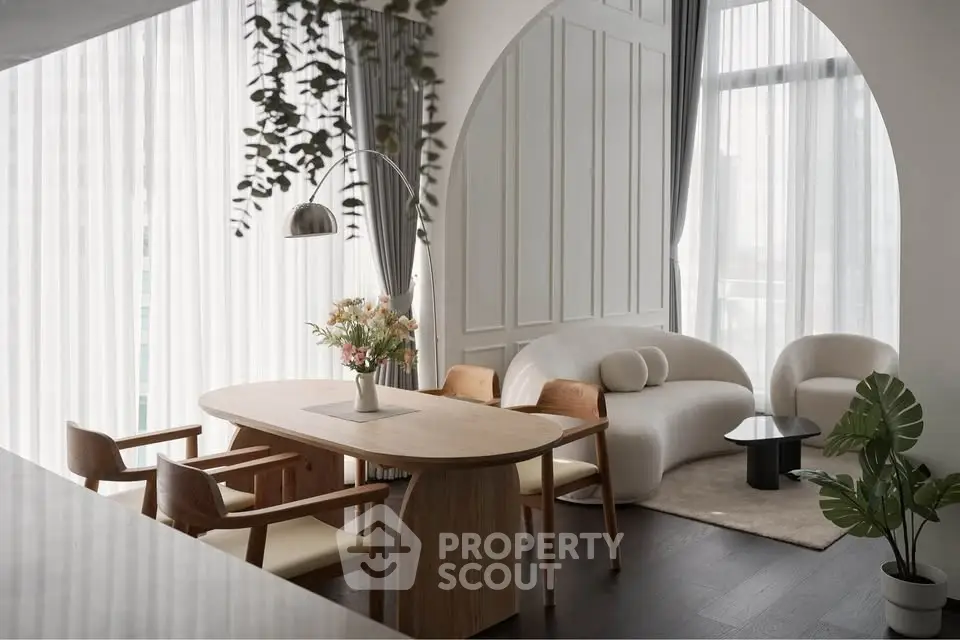 Elegant modern living room with stylish furniture and large windows, perfect for urban living.