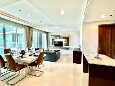 Luxurious open-plan living and dining area with modern decor and large windows.