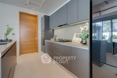 Modern kitchen with sleek cabinetry and gas stove in luxury home