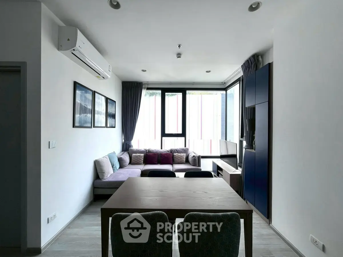 Modern living room with large windows and stylish furniture