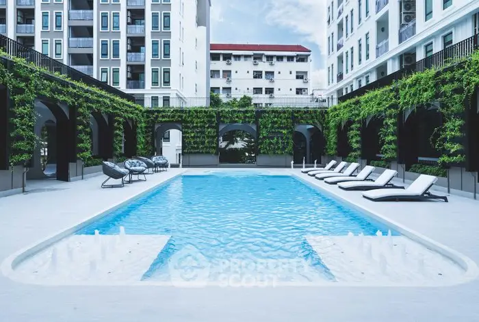 Luxurious apartment complex with stunning pool and lush greenery