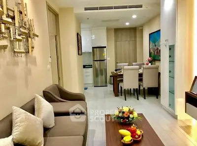 Modern living room with dining area and stylish decor in a cozy apartment.