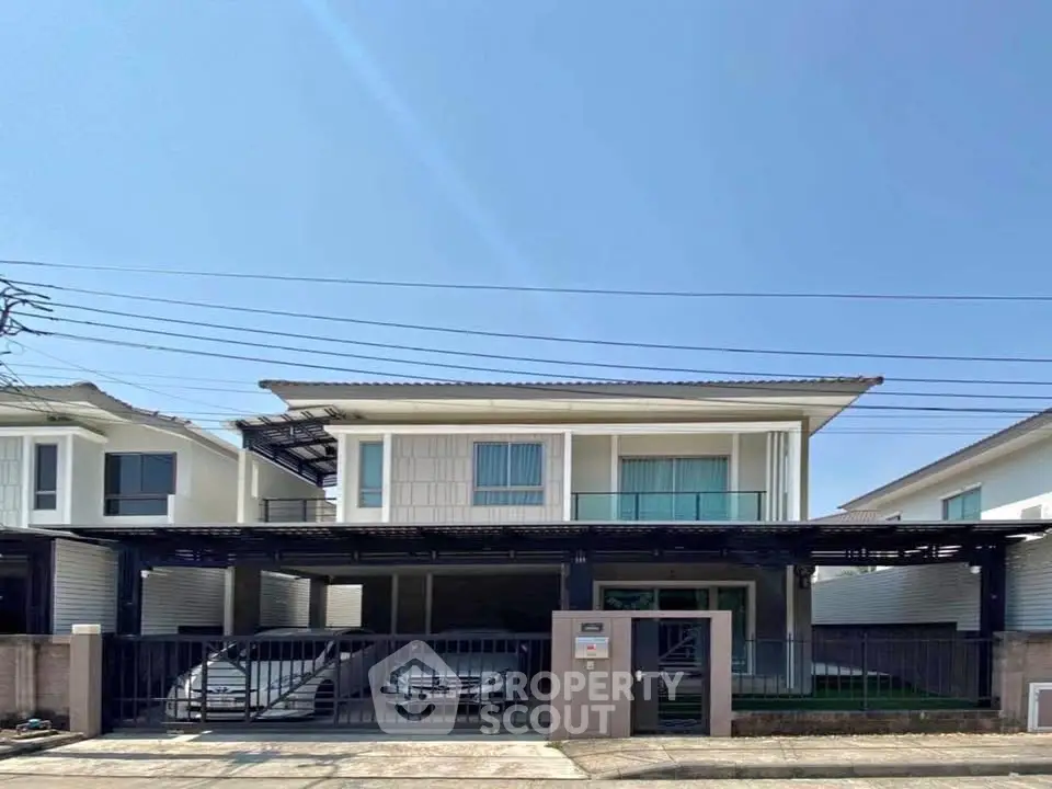 Modern two-story house with carport and sleek exterior design in a suburban neighborhood.