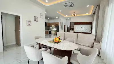 Spacious modern living room with elegant dining area and open kitchen layout