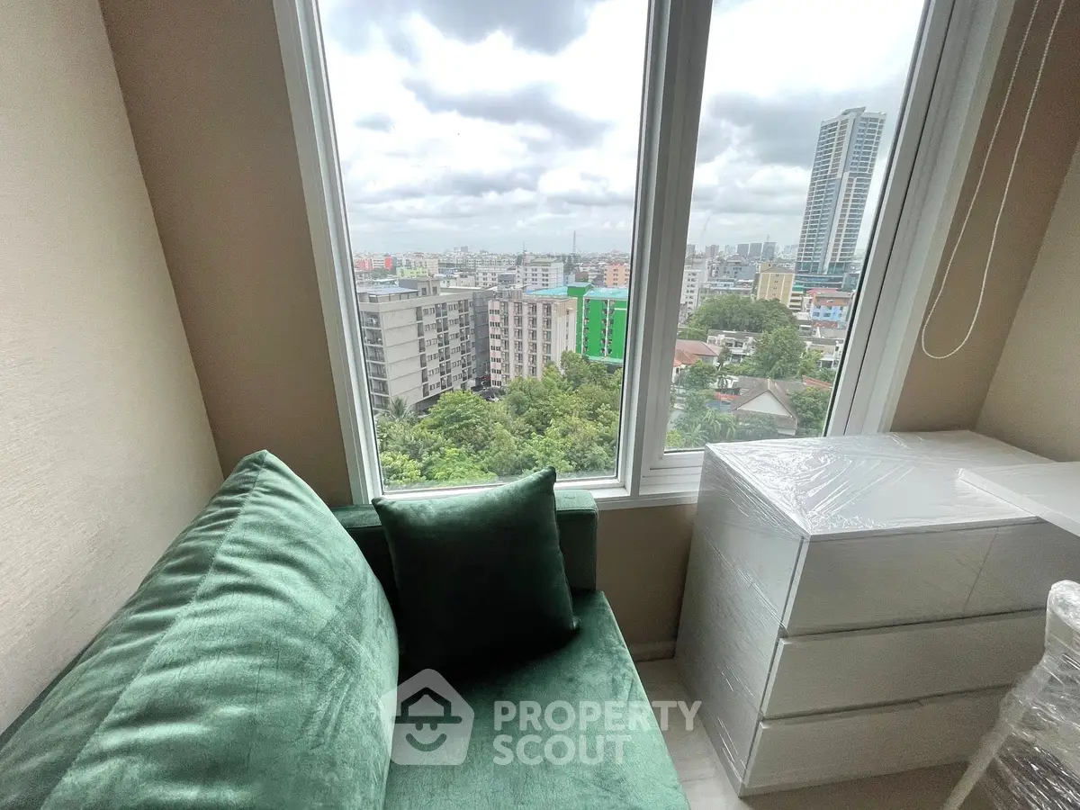 Cozy living room with green sofa and city view from window