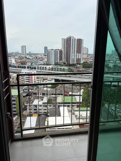 Stunning urban view from a high-rise balcony, showcasing cityscape and modern architecture.