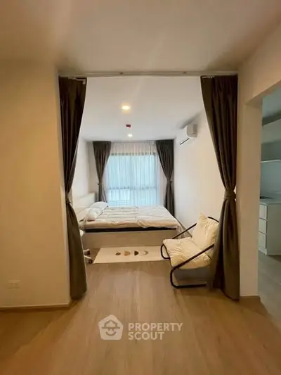 Modern bedroom with cozy decor and natural light, featuring a comfortable bed and stylish curtains.