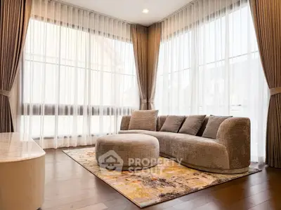 Elegant living room with modern sofa and floor-to-ceiling windows