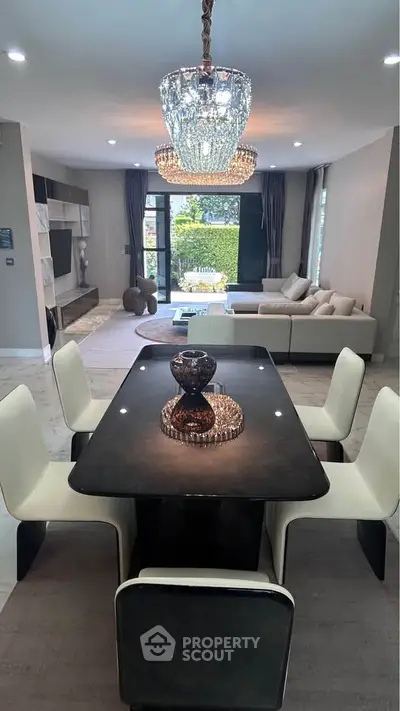 Luxurious modern living room with elegant dining area and stunning chandelier