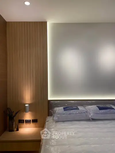 Modern bedroom with stylish wooden paneling and ambient lighting