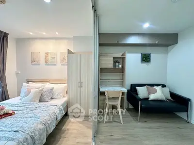 Modern studio apartment with cozy bedroom and stylish living area, featuring elegant decor and ample natural light.