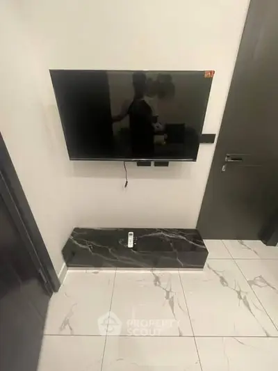 Modern living room with wall-mounted TV and marble floor