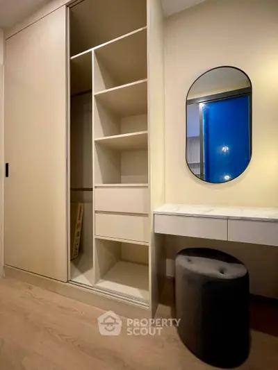 Modern bedroom with built-in wardrobe and stylish vanity area