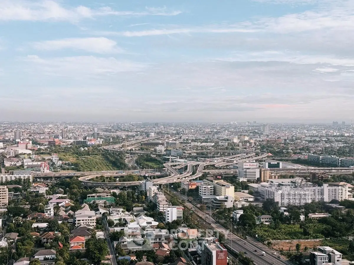 Stunning aerial view of urban landscape with highways and residential areas.