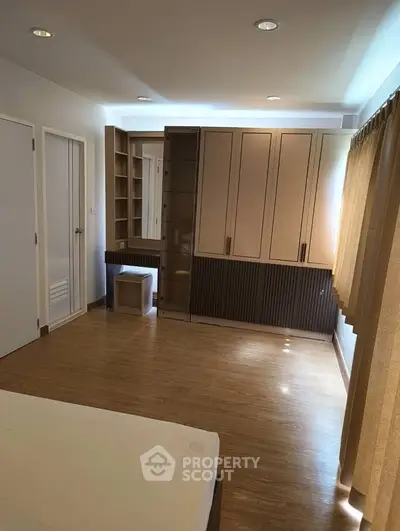 Spacious bedroom with modern built-in wardrobe and natural light