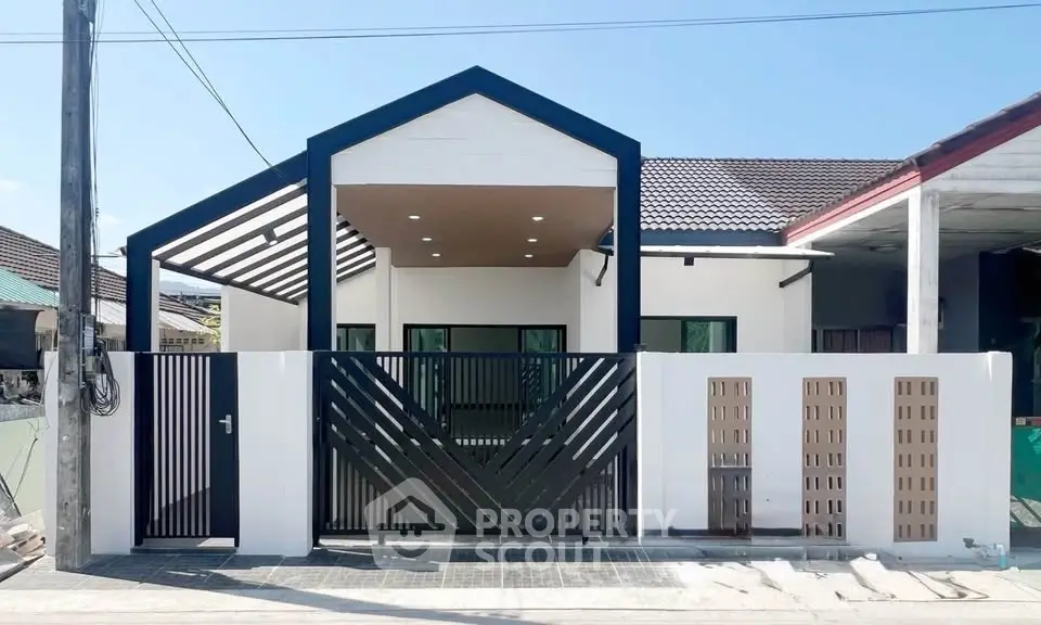 Modern single-story house with unique geometric facade and gated entrance