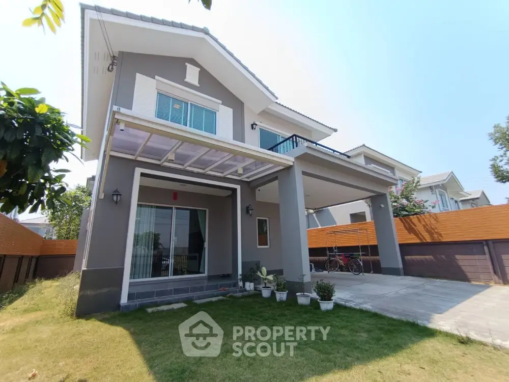 Modern two-story house with spacious driveway and lush garden