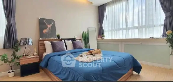 Spacious bedroom with large window and stylish decor