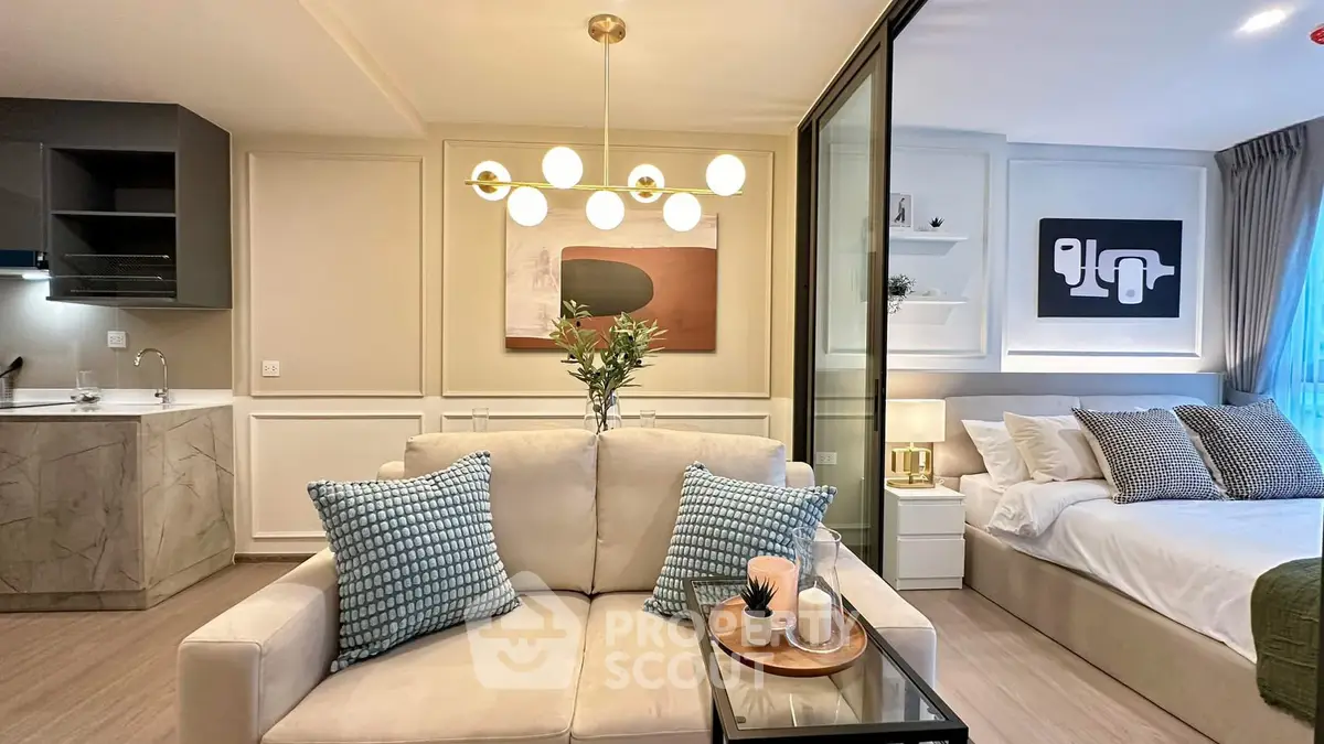 Modern open-plan living room with stylish decor and cozy bedroom area