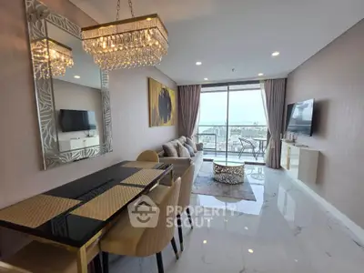 Luxurious living room with elegant chandelier and stunning city view from balcony.