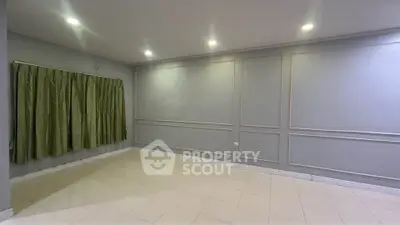 Spacious empty room with elegant wall paneling and tiled flooring, perfect for customization.