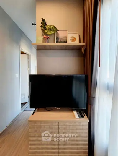 Modern living room with stylish TV setup and decorative shelving
