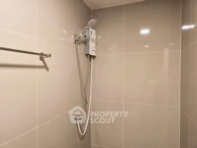 Modern bathroom with sleek shower design and neutral tiles