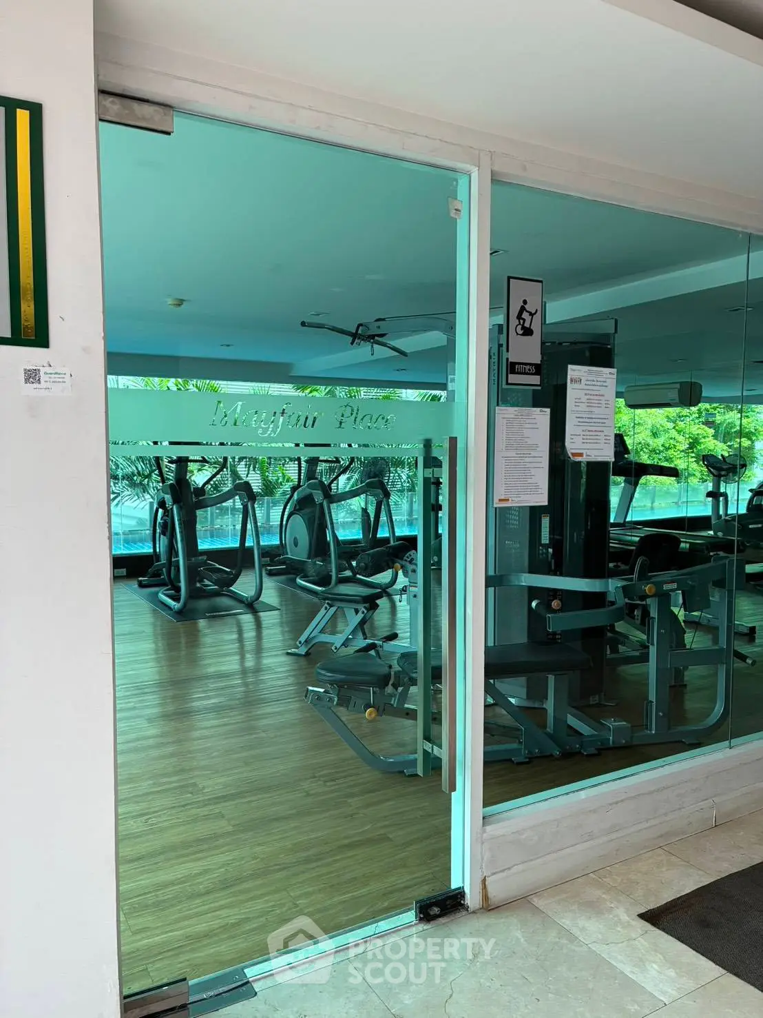 Modern gym with glass doors and fitness equipment in a residential building