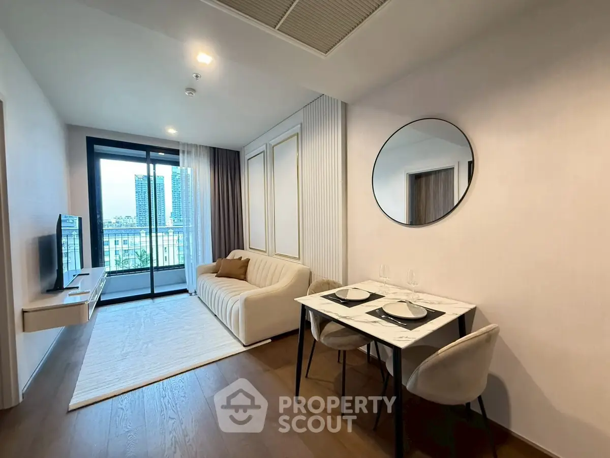 Modern living room with elegant decor and balcony view in luxury apartment.