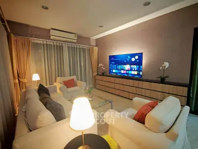 Elegant living room with modern decor and wall-mounted TV, perfect for relaxation and entertainment.