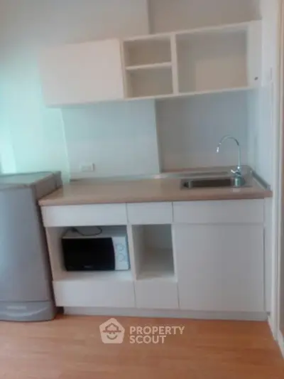 Compact kitchen with modern cabinetry and appliances, perfect for small spaces.