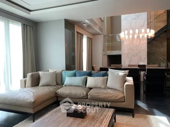Luxurious modern living room with elegant sofa and stylish dining area, perfect for entertaining.