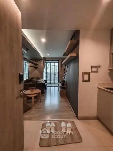 Modern open-layout living room with cozy decor and balcony view