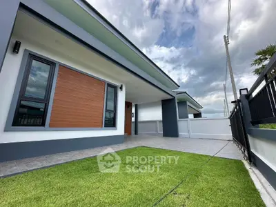 Modern single-story home with sleek design and spacious front yard