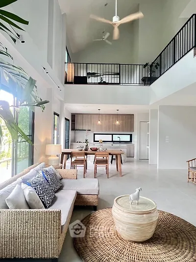 Spacious modern living room with high ceilings and open kitchen layout