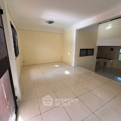 Spacious tiled living area with natural light and open layout, perfect for modern living.