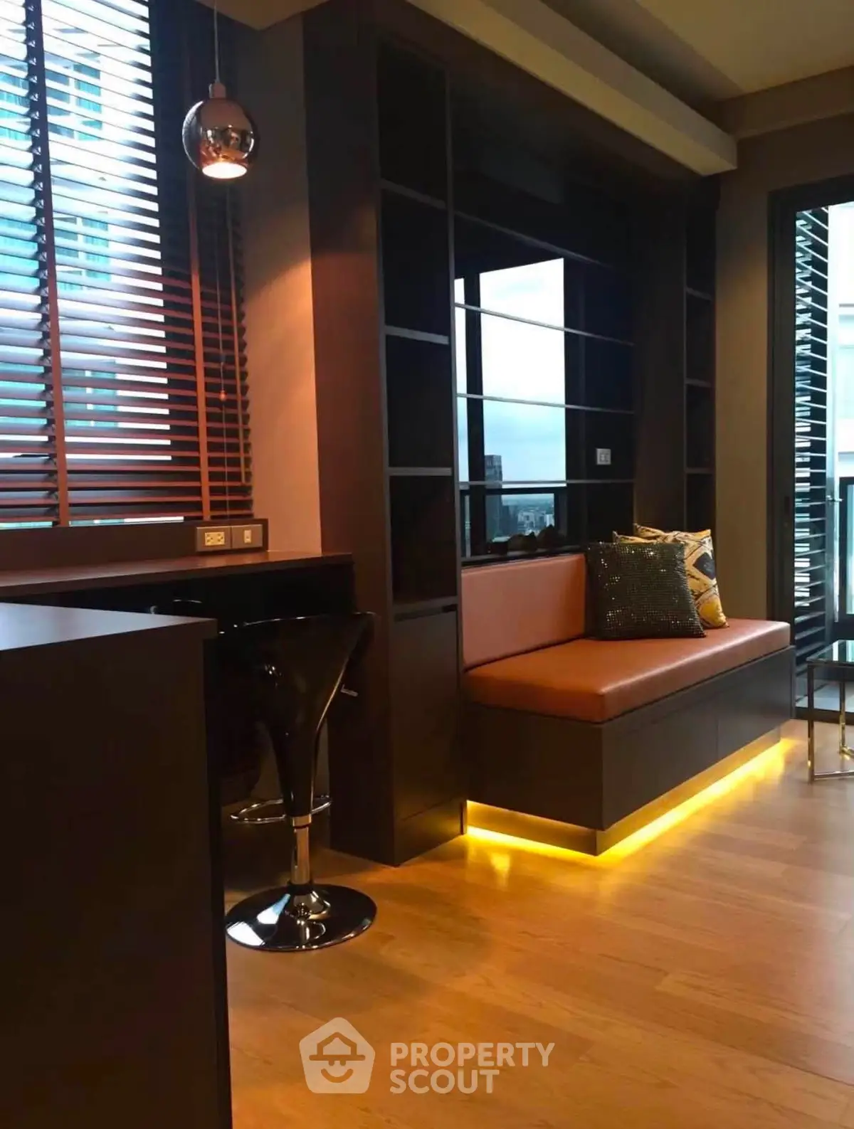 Modern living room with stylish seating and ambient lighting in a contemporary apartment.