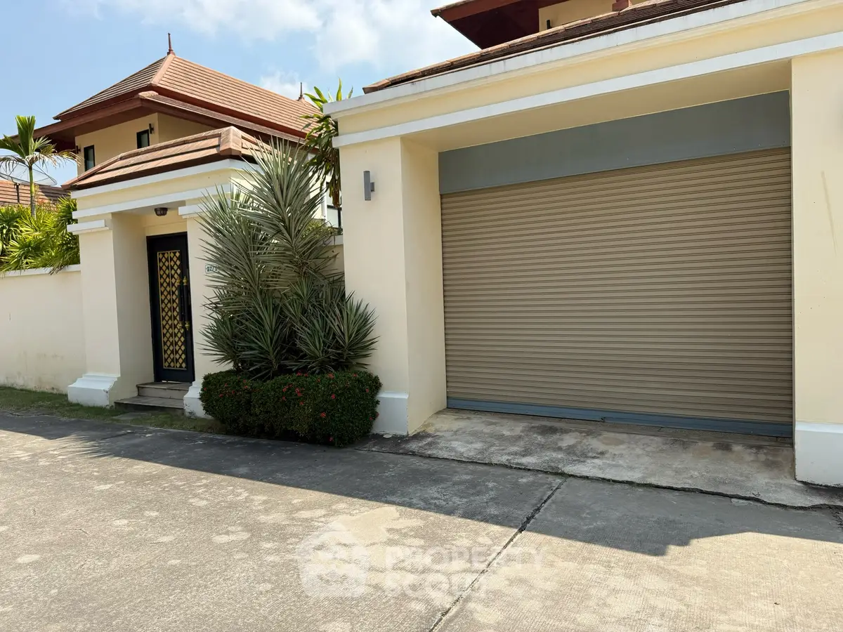 Elegant residential entrance with garage in a tropical setting