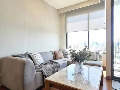 Bright living room with cozy sofa and city view, perfect for relaxation.